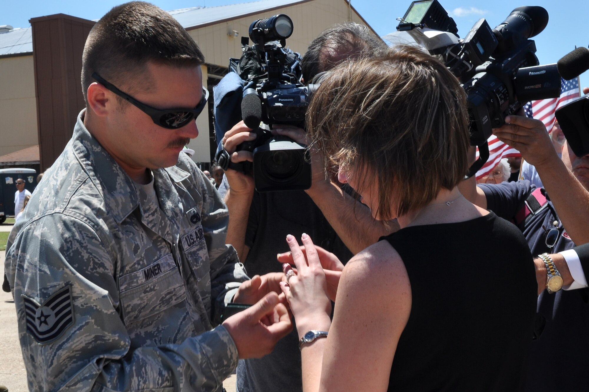 Tech. Sgt. Keith Miner, a crew chief assigned to the 917th Fighter Group, slips an engagement ring onto the finger of his fiancé, Miranda O’Dell at Barksdale Air Force Base, La., April 17, 2012. Miner proposed to O’Dell in front of a large crowd of well wishers and numerous media. (U.S. Air Force photo by Betty Stephens)  