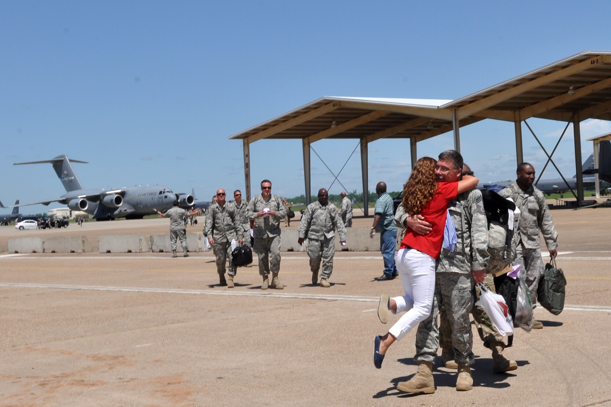 Chief Master Sgt. Stacy Bauer, the maintenance superintendent for the 917th Aircraft Maintenance Squadron, receives a warm welcome home hug at Barksdale Air Force Base, La., April 17, 2012. Bauer was one of the final 47 Airmen from the 917 Fighter Group to return home from a deployment to Afghanistan. (U.S. Air Force photo by Betty Stephens)  