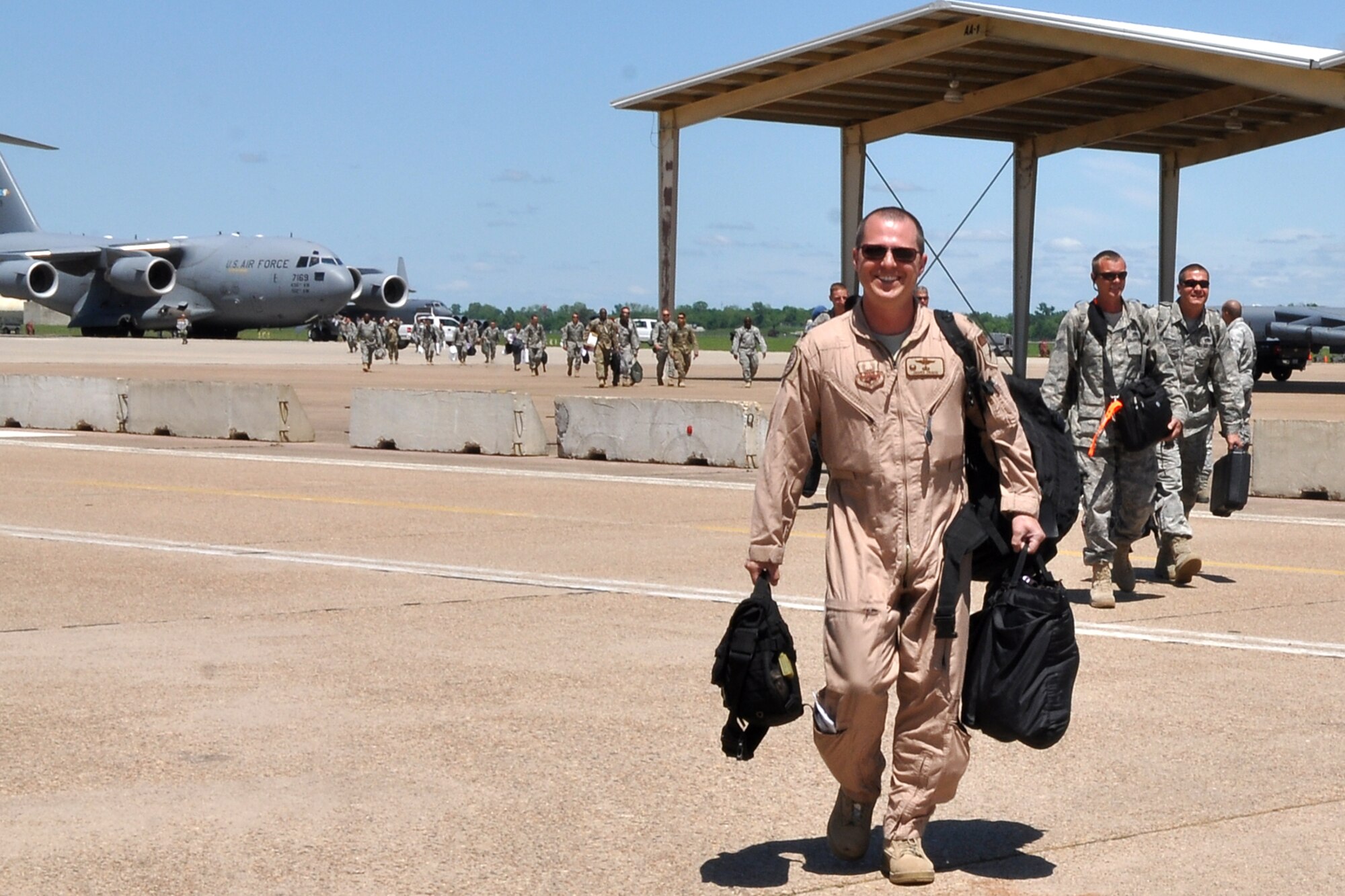Lt. Col. James Travis, the commander of the 47th Fighter Squadron, leads the final group of returning Airmen from the 917th Fighter Group across the flightline at Barksdale Air Force Base, La., April 17, 2012. A C-17 Globemaster III from the 436th Airlift Wing, Dover Air Force Base, Del., carried the Airmen from the 917 FG who were returning from a deployment to Afghanistan. (U.S. Air Force photo by Betty Stephens)  