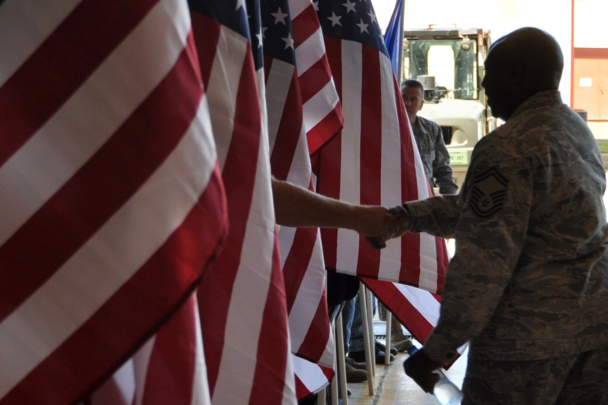 Senior Master Sgt. Bernard Woods, an Air Reserve Technician assigned to the 917th Aircraft Maintenance Squadron, thanks a member of the Patriot Guard Riders in the A-10 Hangar at Barksdale Air Force Base, La., April 17, 2012. Woods just returned from a deployment to Afghanistan.  The Patriot Guard Riders is a diverse amalgamation of riders from across the nation who have an unwavering respect for those who risk their lives for America’s freedom and security. Woods was one of the final 47 Airmen from the 917th Fighter Group to return home from a deployment to Afghanistan. (U.S. Air Force photo by Master Sgt. Jeff Walston)  