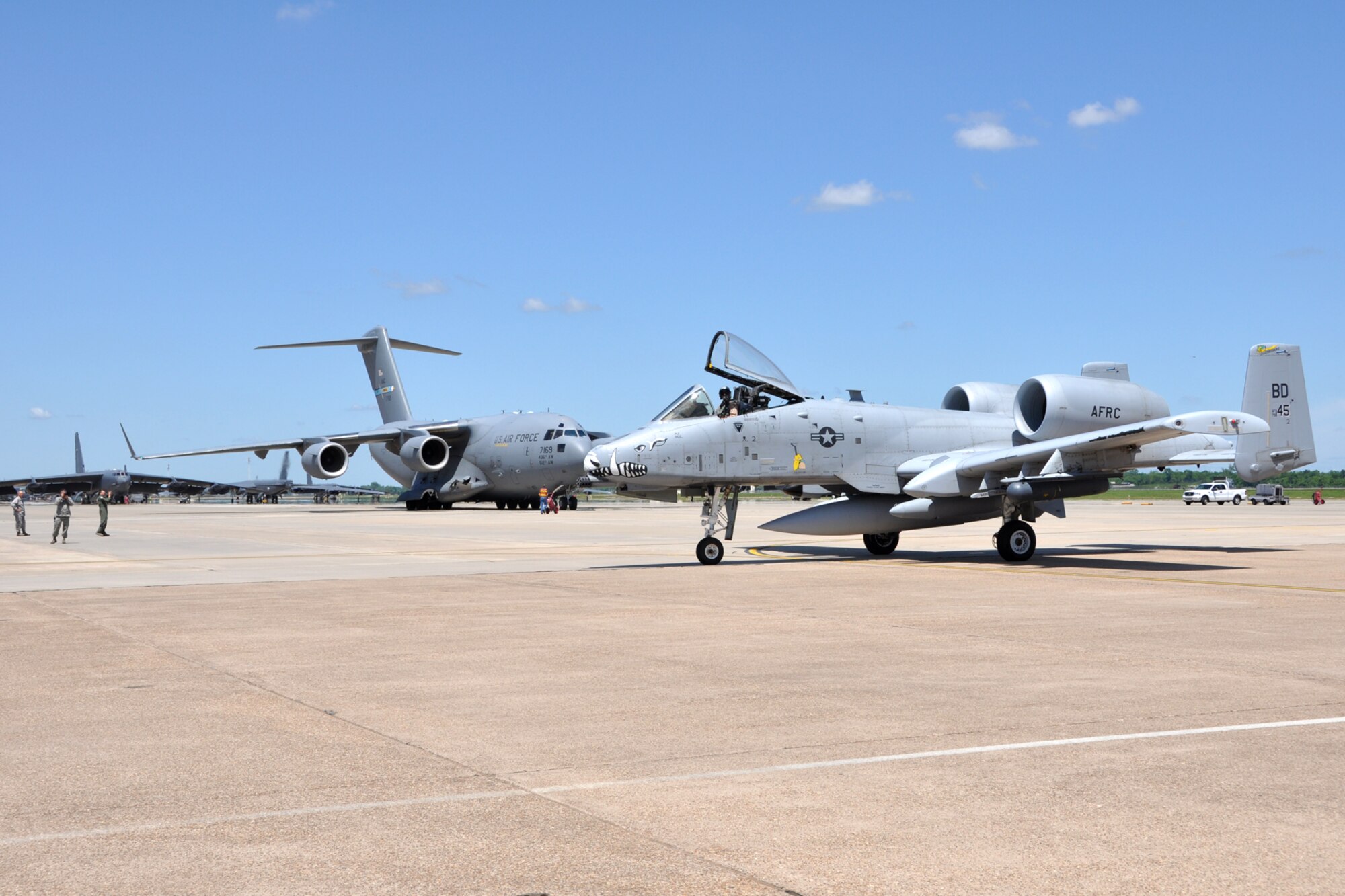 Lt. Col. Rodney Glass, an A-10 Thunderbolt II pilot assigned to the 47th Fighter Squadron, taxis his jet past a C-17 Globemaster III at Barksdale Air Force Base, La., April 17, 2012. Glass piloted the final A-10 from the 917th Fighter Group that was used during their deployment to Afghanistan into Barksdale AFB. The C-17, from the 436th Airlift Wing, Dover Air Force Base, carried the final 47 Airmen from the 917 FG who were also deployed to Afghanistan. (U.S. Air Force photo by Master Sgt. Jeff Walston)  