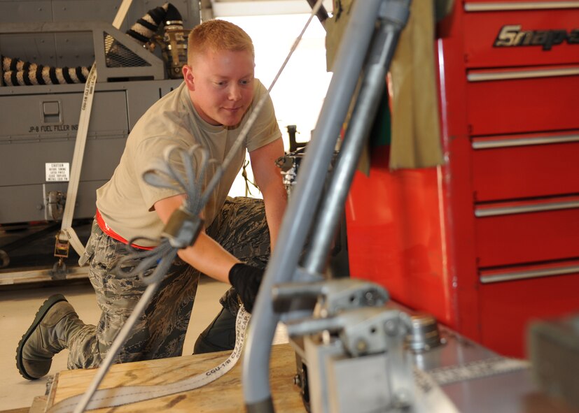 Senior Airman Garret Miron, 22nd Maintenance Squadron aerial ground equipment journeyman, tightens the straps on a pallet during an operational readiness exercise April 2, 2012, McConnell Air Force Base, Kan. Garrett and other Airmen build11 pallets during the exercise and showed their ability to deploy to a new location. (U.S. Air Force photo/Airman 1st Class Maurice Hodges)
