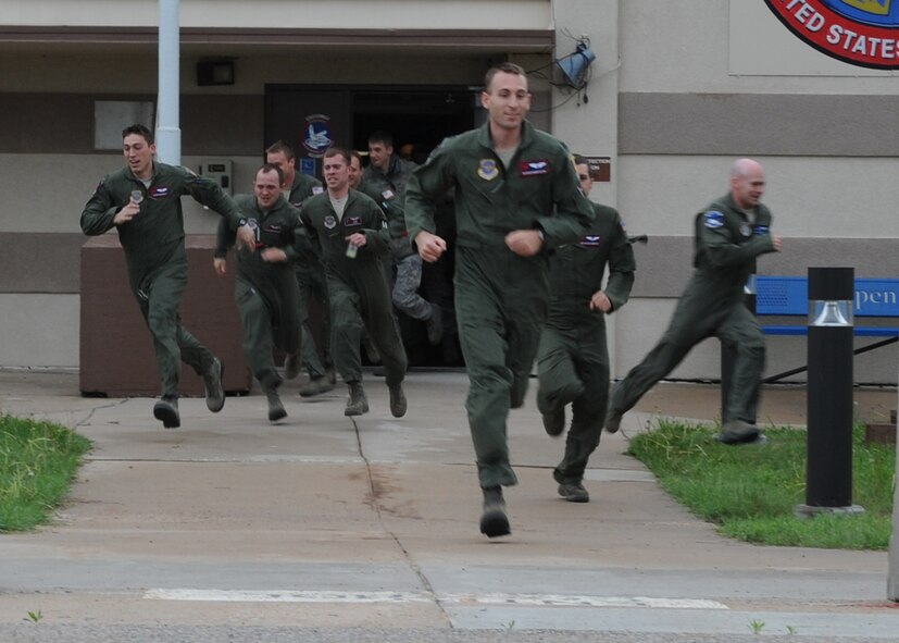 Aircrew members sprint to KC-135 Stratotankers during an operational readiness exercise April 5, 2012, McConnell Air Force Base, Kan. The mobility exercise demonstrated how air and ground crews can successfully launch multiple aircraft in a short period of time. (U.S. Air Force photo/Airman 1st Class Maurice Hodges)
