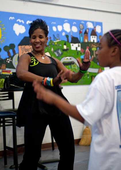 Christina Walker-Potts, Zumba instructor, leads an Earth Day inspired Zumba session for children April 18, 2012 at the youth center on Moody Air Force Base, Ga. This year, Moody incorporated First Lady Michelle Obama’s Let’s Move initiative with Earth Week using Zumba that feature songs about things in the environment. (U.S. Air Force photo by Airman 1st Class Jarrod Grammel/Released)
