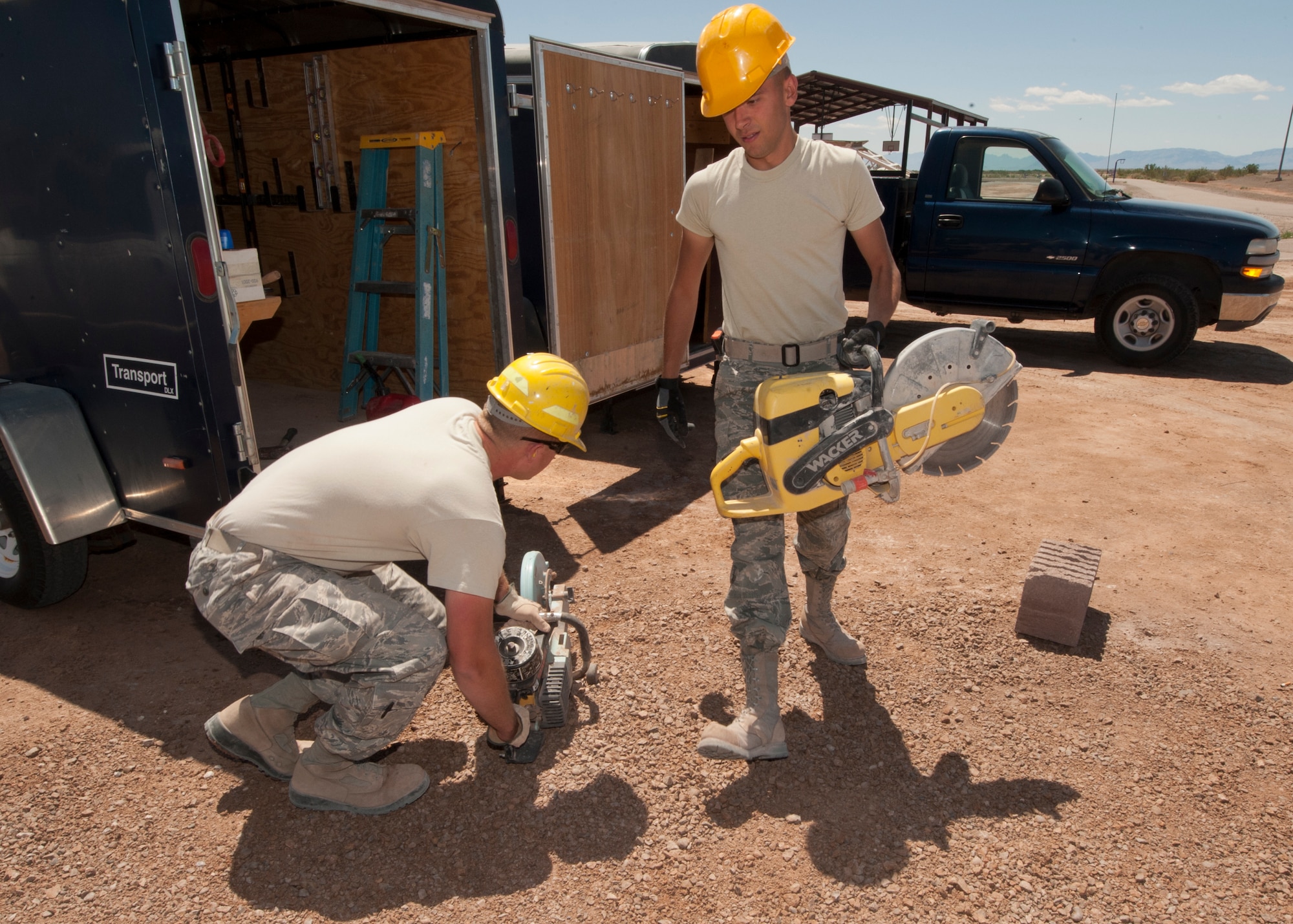 HOLLOMAN AIR FORCE BASE, N.M. – Staff Sgt. Joseph Hosak, 49th Civil Engineer Squadron structures craftsman, and Airman 1st Class Brooks Dubois, 49th CES structures apprentice, power up saws April 16. The Airmen cut bricks to be used on a restroom for the outdoor sports complex. The 49th CES has teams of Airmen who build structures all over Holloman AFB. (U.S. Air Force photo by Airman Leah Ferrante/Released)