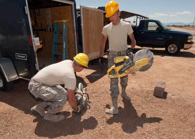 HOLLOMAN AIR FORCE BASE, N.M. – Staff Sgt. Joseph Hosak, 49th Civil Engineer Squadron structures craftsman, and Airman 1st Class Brooks Dubois, 49th CES structures apprentice, power up saws April 16. The Airmen cut bricks to be used on a restroom for the outdoor sports complex. The 49th CES has teams of Airmen who build structures all over Holloman AFB. (U.S. Air Force photo by Airman Leah Ferrante/Released)