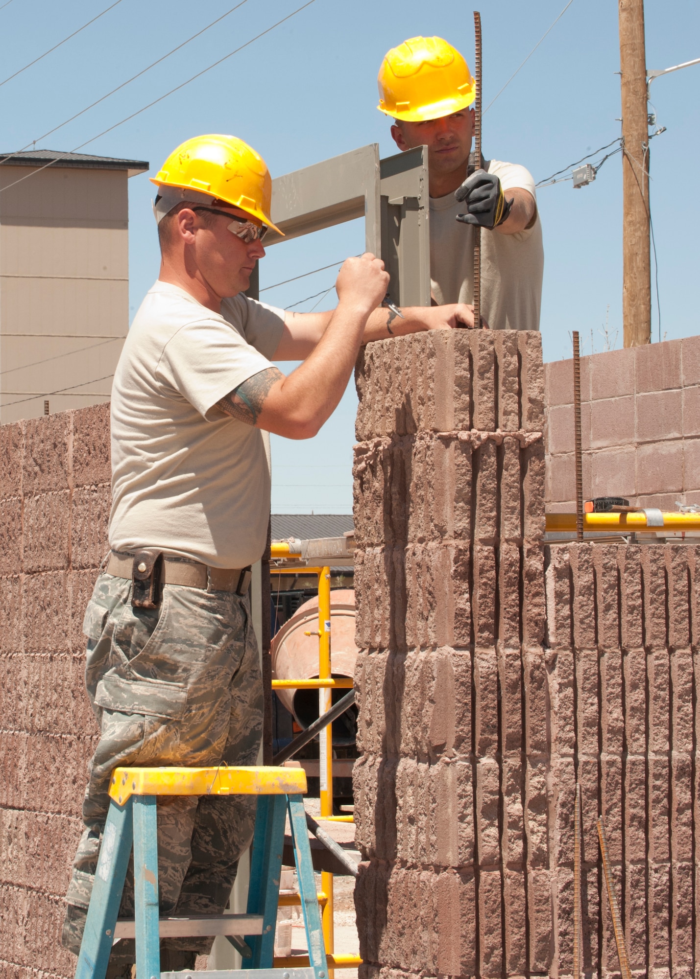 HOLLOMAN AIR FORCE BASE, N.M. – Staff Sgt. Joseph Hosak, 49th Civil Engineer Squadron structures craftsman, and Airman 1st Class Brooks Dubois, 49th CES structures apprentice, measure a structure April 16. The Airmen made sure everything was measured properly in order to lay more bricks for a restroom at the outdoor sports complex. The 49th CES has teams of Airmen who build structures all over Holloman AFB. (U.S. Air Force photo by Airman Leah Ferrante/Released)
