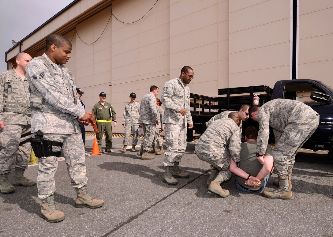 94th Aeromedical Staging Squadron personnel secure a patient after he was found to be armed while processing into the Contingency Aeromedical Staging Facility during a mass casualty exercise at Dobbins Air Reserve Base, Ga., Apr. 15.  The exercise tested the ability of the Georgia State Defense Force to work with 94th Airlift Wing military personnel in treating and evacuating natural disaster victims from the Atlanta area.  (U.S. Air Force photo/ Brad Fallin)
