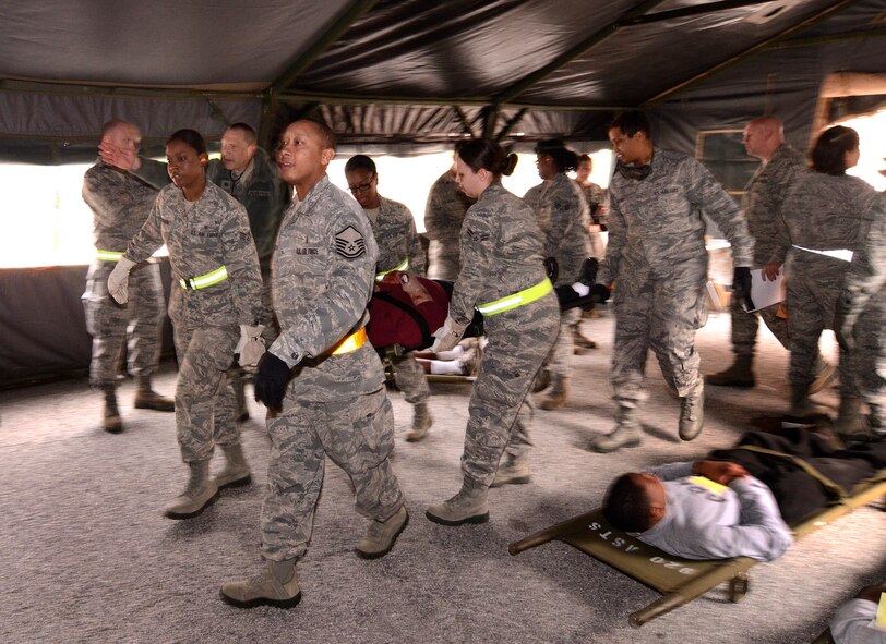 94th Aeromedical Staging Squadron personnel bring another patient into the Contingency Aeromedical Staging Facility to await transportation to a regional hospital, during a mass casualty exercise at Dobbins Air Reserve Base, Ga., Apr. 15.  The exercise tested the ability of the Georgia State Defense Force to work with 94th Airlift Wing military personnel in treating and evacuating natural disaster victims from the Atlanta area.  (U.S. Air Force photo/ Brad Fallin)