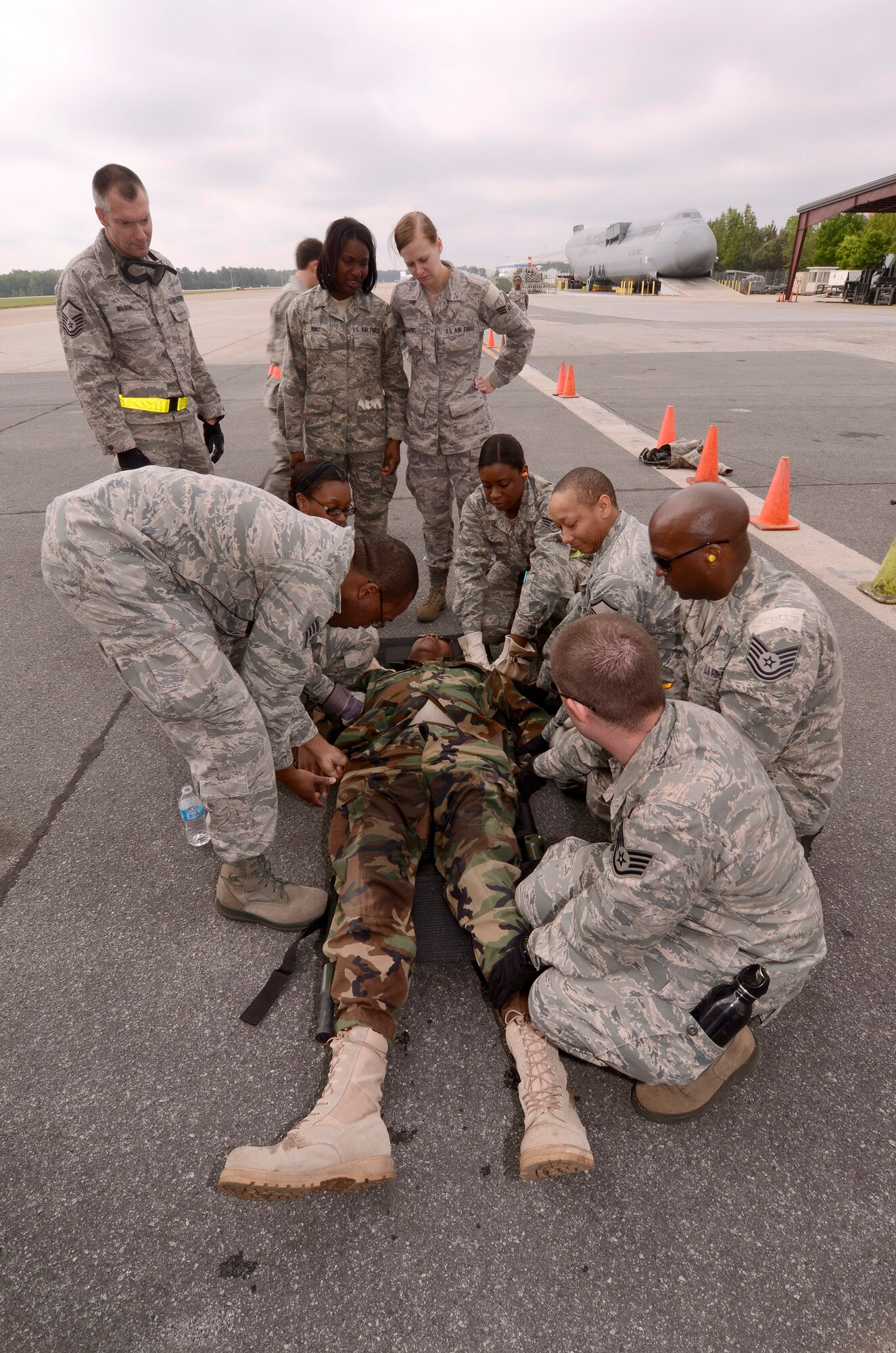 94th Aeromedical Staging Squadron personnel work to get a newly arrived patient properly secured on a stretcher and into the Contingency Aeromedical Staging Facility, during a mass casualty exercise at Dobbins Air Reserve Base, Ga., Apr. 15.  The exercise tested the ability of the Georgia State Defense Force to work with 94th Airlift Wing military personnel in treating and evacuating natural disaster victims from the Atlanta area.  (U.S. Air Force photo/ Brad Fallin)