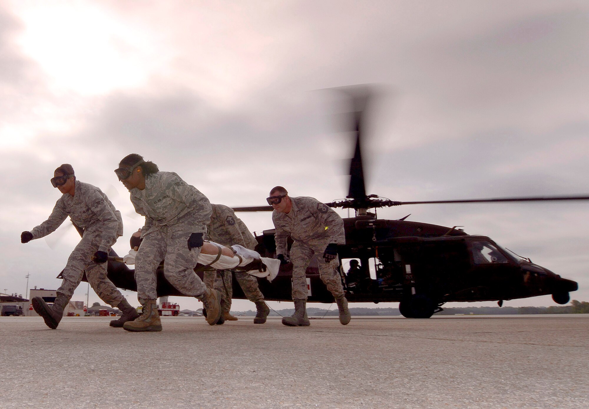94th Aeromedical Staging Squadron personnel carry a patient away from the Georgia Army National Guard helicopter during a mass casualty exercise at Dobbins Air Reserve Base, Ga., Apr. 15.  The exercise tested the ability of the Georgia State Defense Force to work with 94th Airlift Wing military personnel in treating and evacuating natural disaster victims from the Atlanta area.  (U.S. Air Force photo/ Brad Fallin)