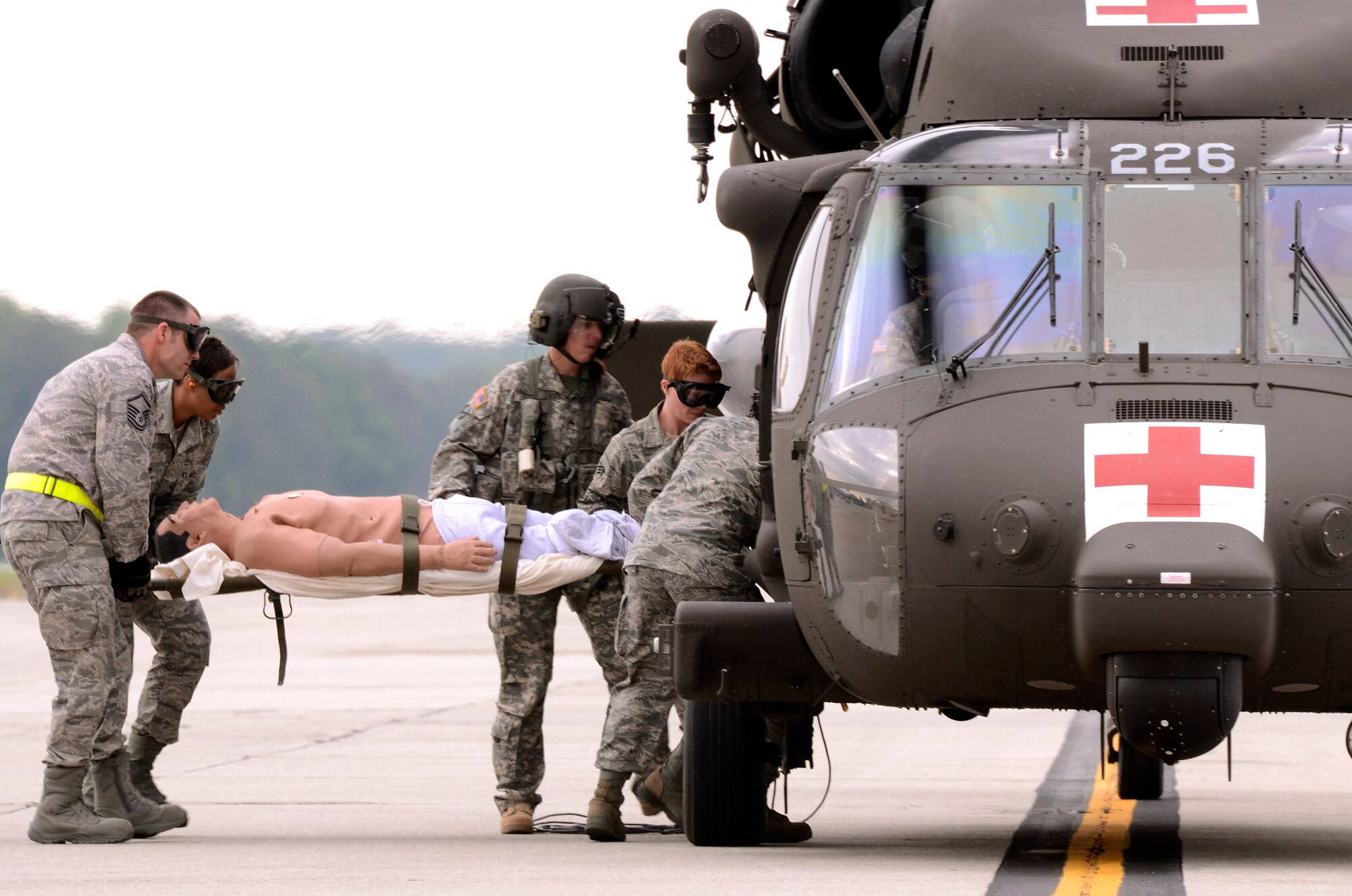 94th Aeromedical Staging Squadron personnel load a patient into a Georgia Army National Guard helicopter during a mass casualty exercise at Dobbins Air Reserve Base, Ga., Apr. 15.  The exercise tested the ability of the Georgia State Defense Force to work with 94th Airlift Wing military personnel in treating and evacuating natural disaster victims from the Atlanta area.  (U.S. Air Force photo/ Brad Fallin)