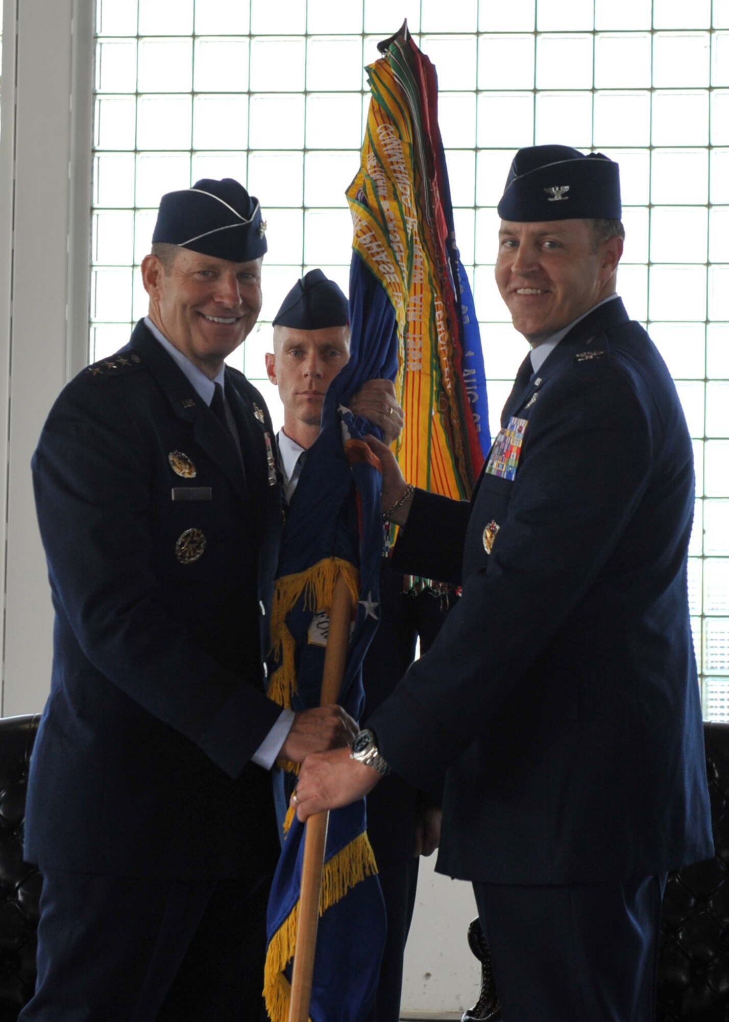 U.S. Air Force Lt. Gen. Robin Rand, commander of 12th Air Force, Air Combat Command, passes the 366th Fighter Wing guidon to Col. Christopher M. Short, 366th FW incoming commander, during a change of command ceremony April 20, 2012, at Mountain Home Air Force Base, Idaho. Short assumes command of the 366th FW from Col. Ron Buckley, who will move to Washington D.C. where he will serve as the Chief of Air Force Senate Liaison. (U.S. Air Force photo/Airman 1st Class Heather Hayward)