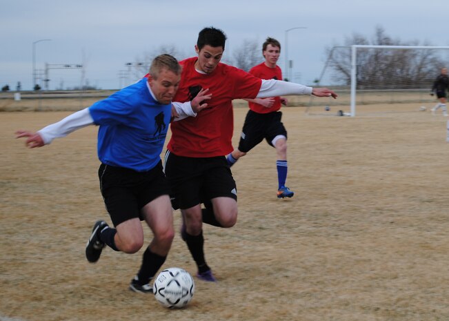1st Lt. Collin McSorley, 10th Missile Squadron deputy missile combat crew commander, left, fights to get the soccer ball back from a C.M. Russell High School player during a soccer game at the Seibel Soccer Park April 16. Airmen from Malmstrom Air Force Base lost to CMR with a final score of 3-1. CMR junior Nicholas Downs organized the game to help raise money for the Wounded Warriors Project, a nonprofit program aimed toward helping wounded war veterans. (U.S. Air Force photo/Airman 1st Class Katrina Heikkinen)