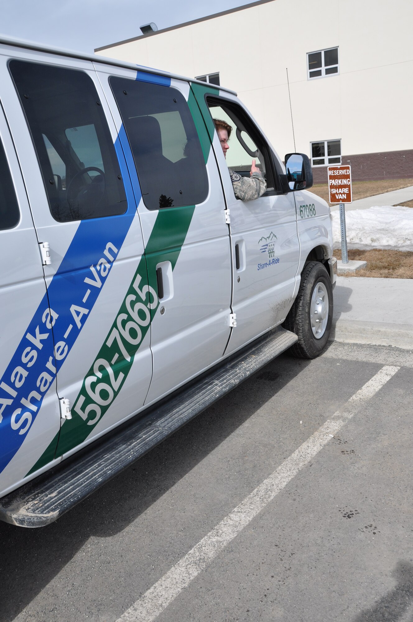 Staff Sgt. Gale Larson, 477th Force Support Squadron, prepares to depart the 477th FG headquarters in a Share-A-Van provided by Anchorage Public Transportation Department. The 477th FG has about 20 members who participate in the van pool. (U.S. Air Force photo/Capt. Ashley Conner) 