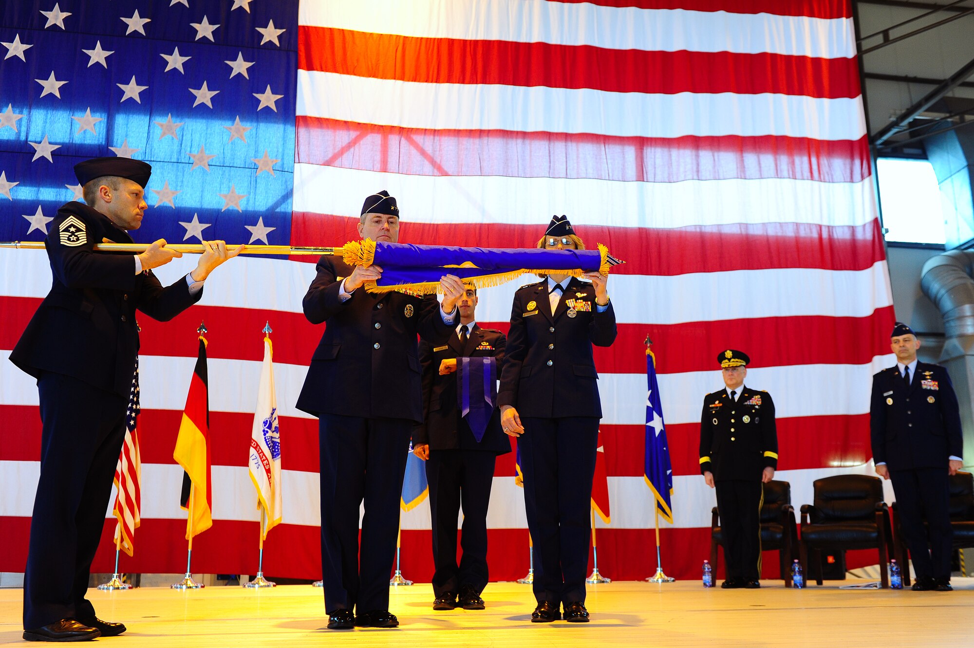 (Left to right) 17th Air Force Command Chief CMSgt Michael Grimm, U.S. Air Forces in Europe Commander Gen. Mark Welsh and 17th AF Commander Maj. Gen. Margaret Woodward furl and case the 17th AF flag during an inactivation ceremony here April 20. The unit, which served as the air component for U.S. Africa
Command, was also designated as Air Forces Africa. During the ceremony, the
Air Forces Africa mission was transferred to USAFE and 3rd Air Force. (U.S. Air Force photo/Airman Basic Brea Miller)
