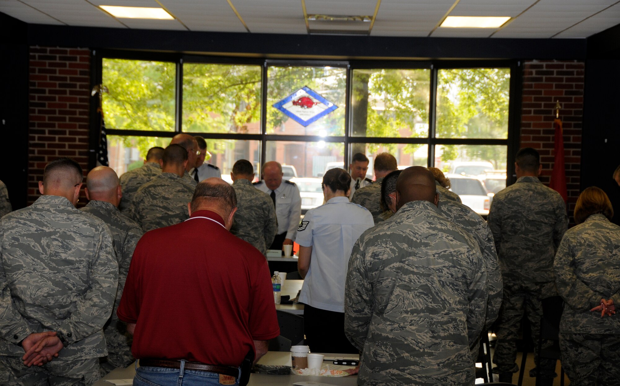 Guests bow their heads in prayer during a prayer breakfast hosted by the 188th Chaplains Office and held at the unit’s Citizen Airmen Dining Hall April 15, 2012. (National Guard photo by Airman 1st Class Hannah Landeros/188th Fighter Wing Public Affairs)