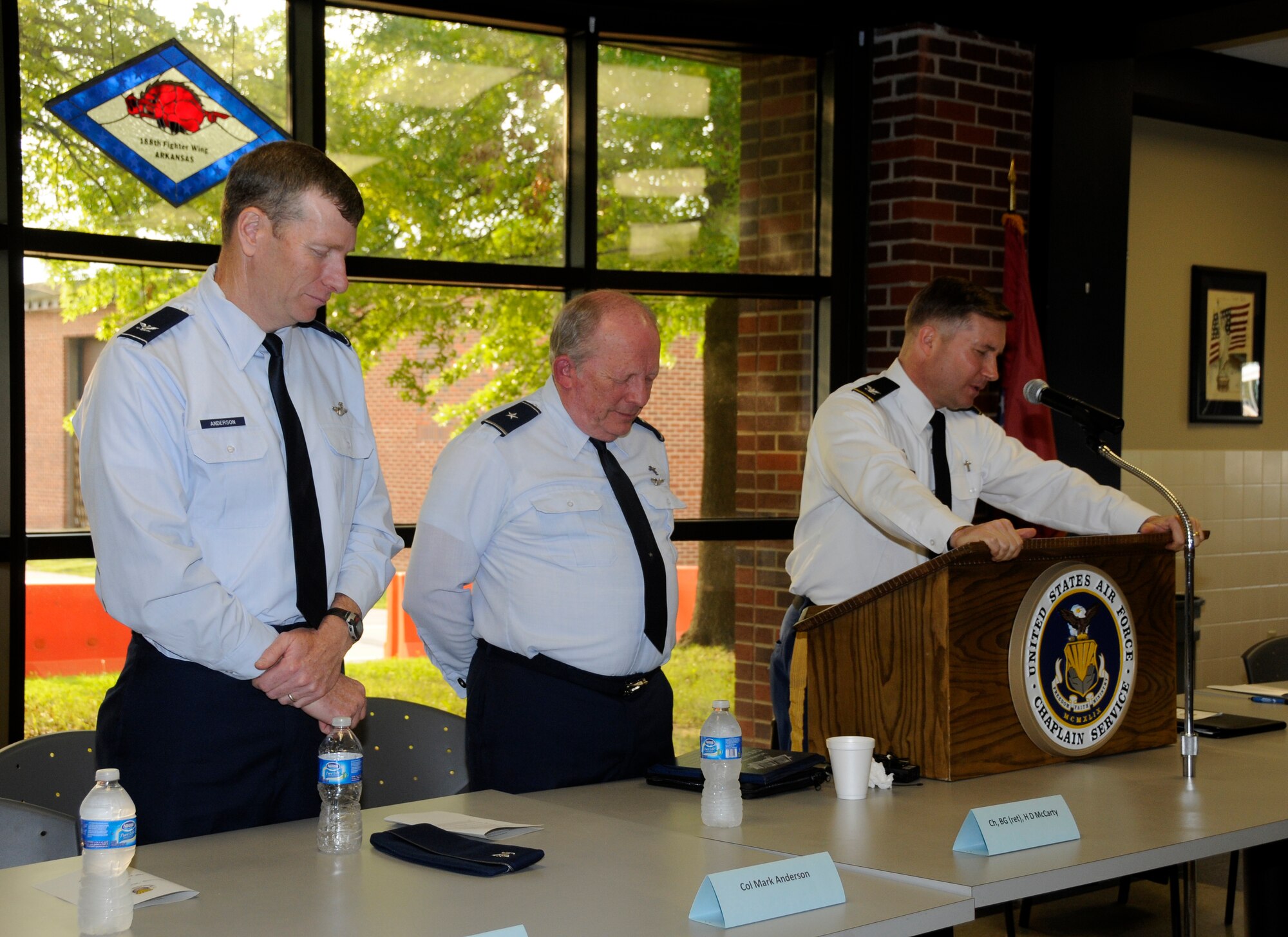 Col. Wes Hilliard, Arkansas National Guard Joint Force Headquarters chaplain, right, leads a group in prayer along with Col. Mark Anderson, 188th Fighter Wing commander, left, and Brig. Gen. (ret.) H.D. McCarty, a former wing chaplain at the 188th Fighter Wing, during a prayer breakfast hosted by the 188th Chaplains Office and held at the unit’s Citizen Airmen Dining Hall April 15, 2012. (National Guard photo by Airman 1st Class Hannah Landeros/188th Fighter Wing Public Affairs)