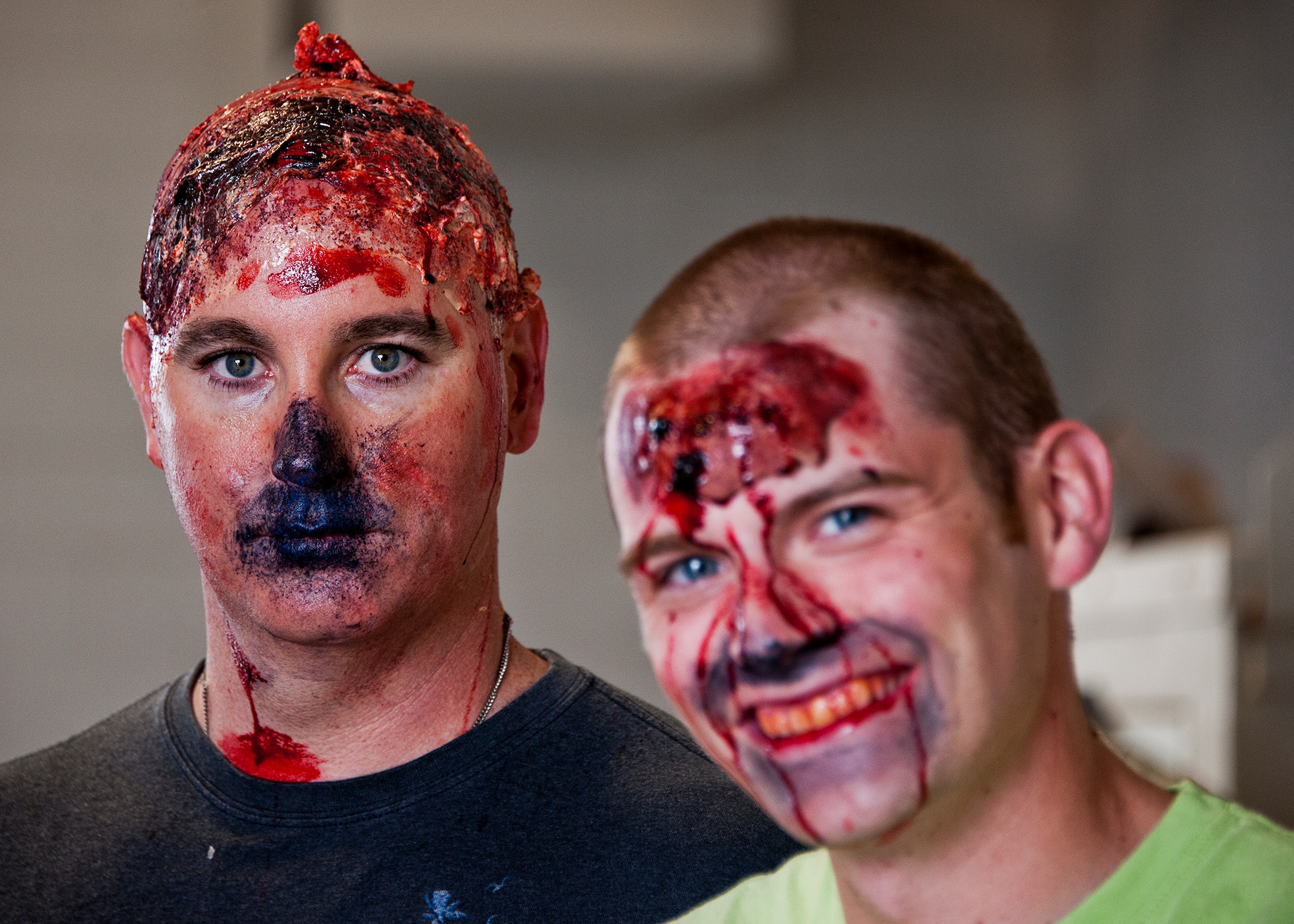 Eric Alexander (left) and others became ‘bloody’ realistic victims for an April 19 mass casualty exercise thanks to the 96th Medical Group’s moulage team.  The team turned more than 40 volunteers into ‘horror movie’ realistic victims of an aircraft fire.  The team’s “art” provides a sense of realism in exercises that medics and first responders may encounter in real-world accidents.  (U.S. Air Force photo/Samuel King Jr.)