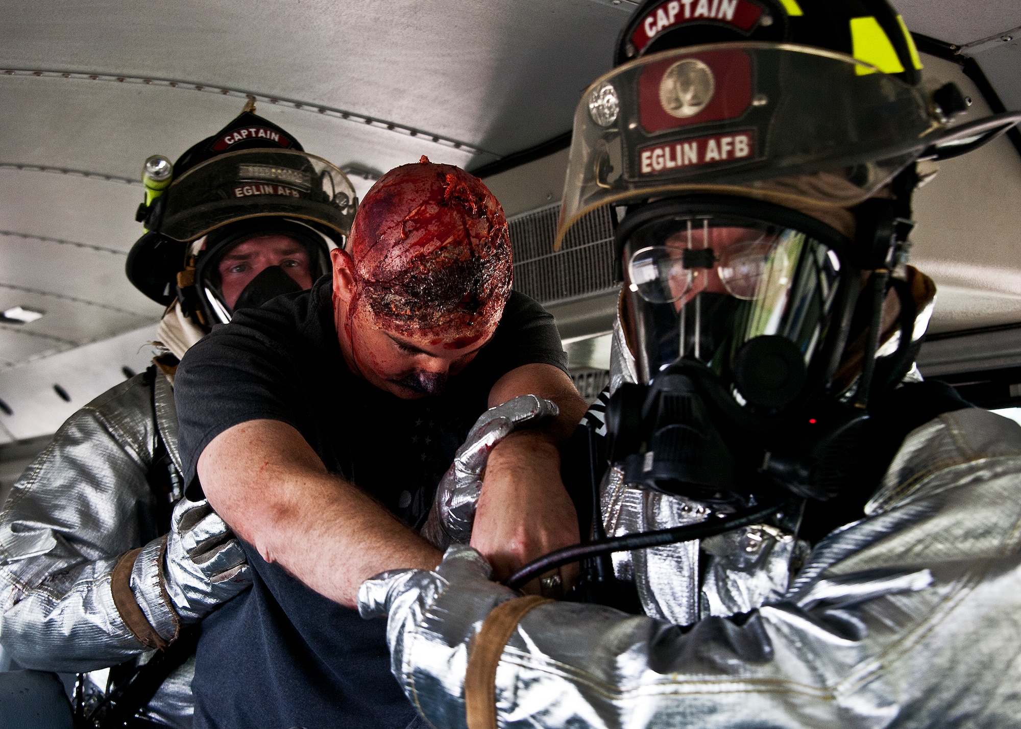 Eric Alexander, a victim of a simulated aircraft fire, is removed from the aircraft during a mass casualty exercise at the Northwest Florida Regional Airport April 19.  The scenario called for emergency units from Eglin, Okaloosa County and the airport to respond to an aircraft on fire containing more than 40 passengers.  Response, communication and accountability were among many procedures under evaluation at the exercise.  Inside the airport, employees were tested on their response to an influx of friends and family members looking for information about the accident.  The Federal Aviation Administration mandates this type of major accident exercise execution every three years.  (U.S. Air Force photo/Samuel King Jr.)