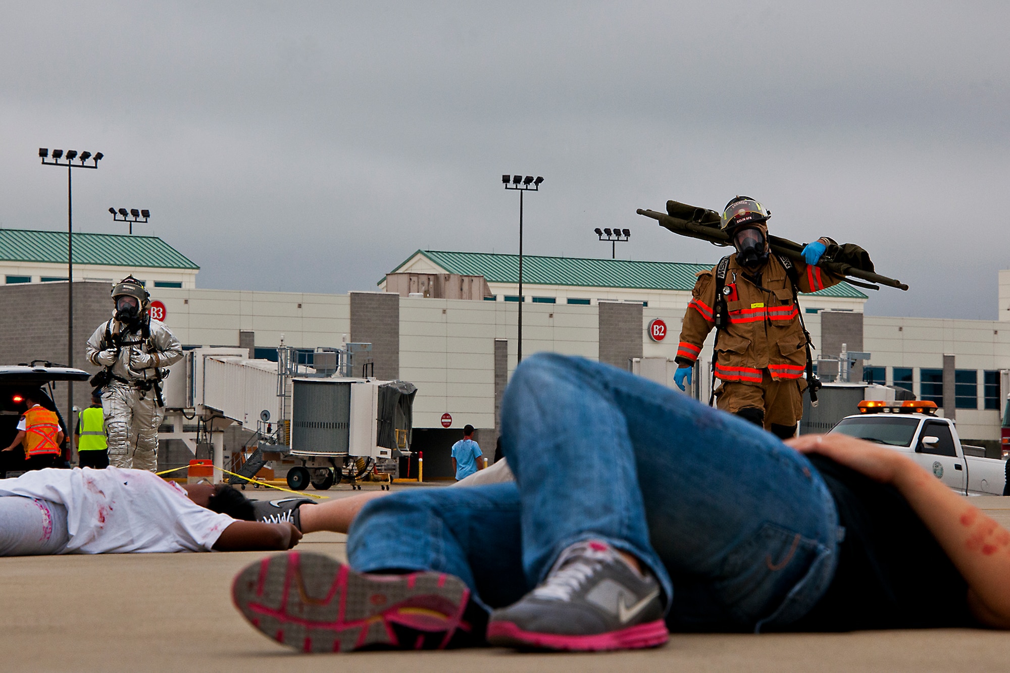 An Eglin firefighter brings out a stretcher to a wounded victim of a simulated aircraft fire during the mass casualty exercise at the Northwest Florida Regional Airport April 19.  The scenario called for emergency units from Eglin, Okaloosa County and the airport to respond to an aircraft on fire containing more than 40 passengers.  Response, communication and accountability were among many procedures under evaluation at the exercise.  Inside the airport, employees were tested on their response to an influx of friends and family members looking for information about the accident.  The Federal Aviation Administration mandates this type of major accident exercise execution every three years.  (U.S. Air Force photo/Samuel King Jr.)