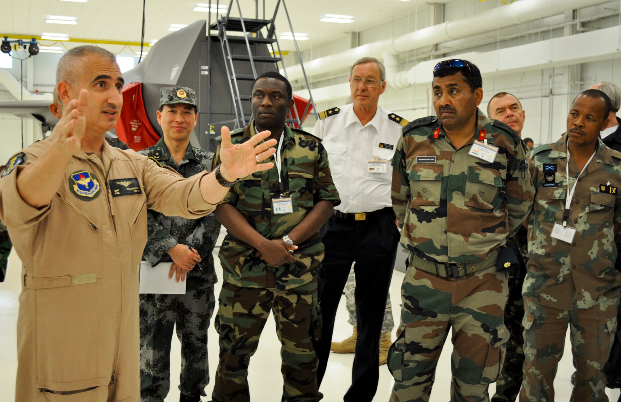 Marine Col. Art Tomassetti, 33rd Fighter Wing vice commander, explains the capabilities of the weapons load trainer, a life-sized F-35 mock-up housed inside the F-35 Academic Training Center to more than 35 foreign officers visiting Eglin Air Force Base, Fla., April 18.  The visit was part of the semiannual Foreign Attaché Operations Orientation, a program created to introduce foreign guests to the U.S. federal agencies’ people and missions as well as expose them to industrial, historical and cultural aspects of American society to enhance direct communications with foreign governments and military commanders among other objectives.  (U.S. Air Force photo/Maj. Karen Roganov) 
