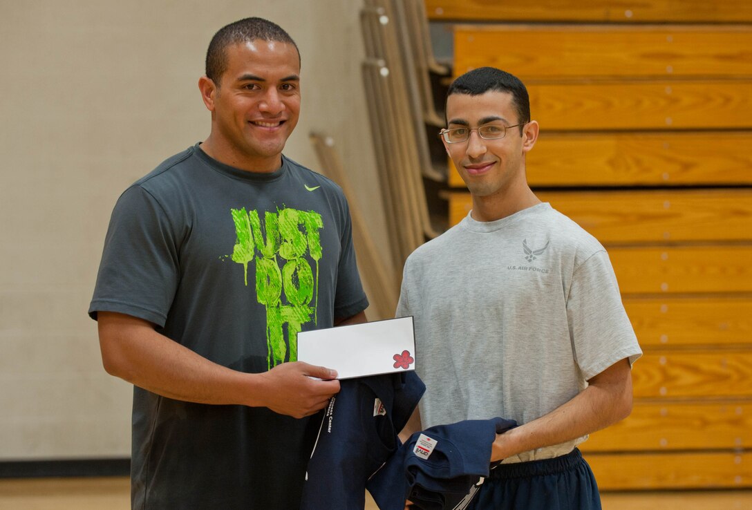 1st Lt. Richie Amisone, 28th Comptroller Squadron financial analysis deputy flight commander, and Airman 1st Class Edwin Santiago, 28th CPTS customer services technician, finished in first place after completing the Amazing Race event on Ellsworth Air Force Base, S.D., April 13, 2012. The top three teams received gift cards and Amazing Race t-shirts. (U.S. Air Force photo by Airman 1st Class Zachary Hada/Released)