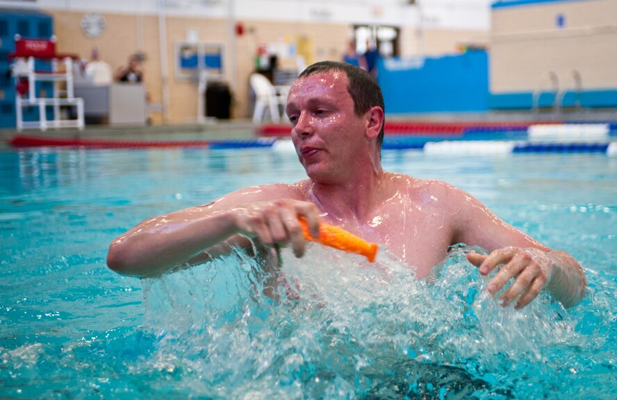 Senior Airman Curt Filkins, 28th Communications Squadron radar technician, retrieves objects from the pool at the Bellamy Fitness Center as part of a challenge during the Amazing Race event hosted by the 28th Force Support Squadron at Ellsworth Air Force Base, S.D., April 13, 2012. Participants had to perform challenges at the fitness center, base pool, Pride Hangar, flight kitchen, Black Hills center, Holbrook Library and Heritage Lake in order to complete the competition. (U.S. Air Force photo by Airman 1st Class Zachary Hada/Released)