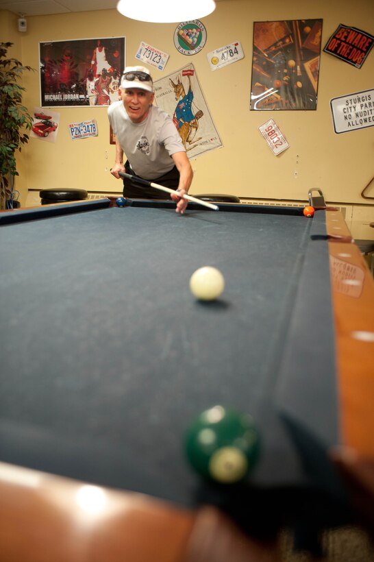 Col. Gary Miller, inactive reservist, attempts to complete a pool shot challenge during the Amazing Race competition at Ellsworth Air Force Base, S.D., April 13, 2012. Twenty teams competed in the event that included seven challenges along a three-mile course. (U.S. Air Force photo by Airman 1st Class Zachary Hada/Released)