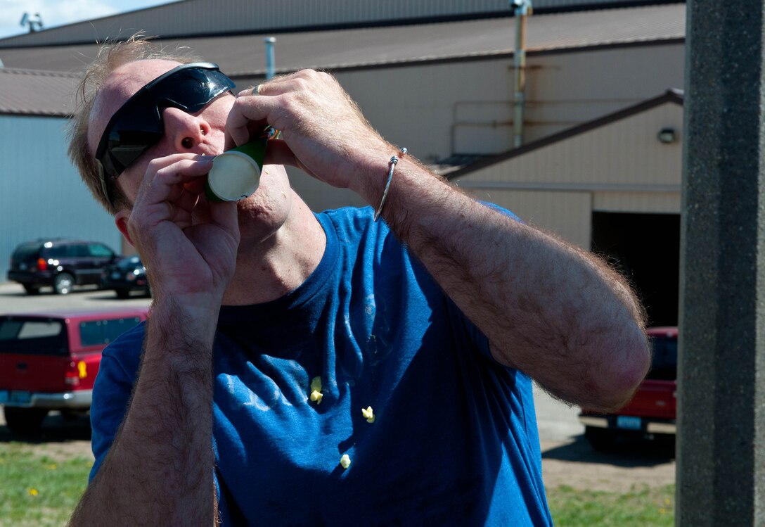 Maj. Bryan Kemper, 28th Medical Operations Squadron chief of optometry, downs a mystery drink comprised of cottage cheese, mustard and pickle as part of a challenge during the Amazing Race competition at Ellsworth Air Force Base, S.D., April 13, 2012. During the competition, participants had to run a three-mile course across Ellsworth to find and complete seven challenge stations with prizes given to the top three teams. (U.S. Air Force photo by Airman 1st Class Zachary Hada/Released)