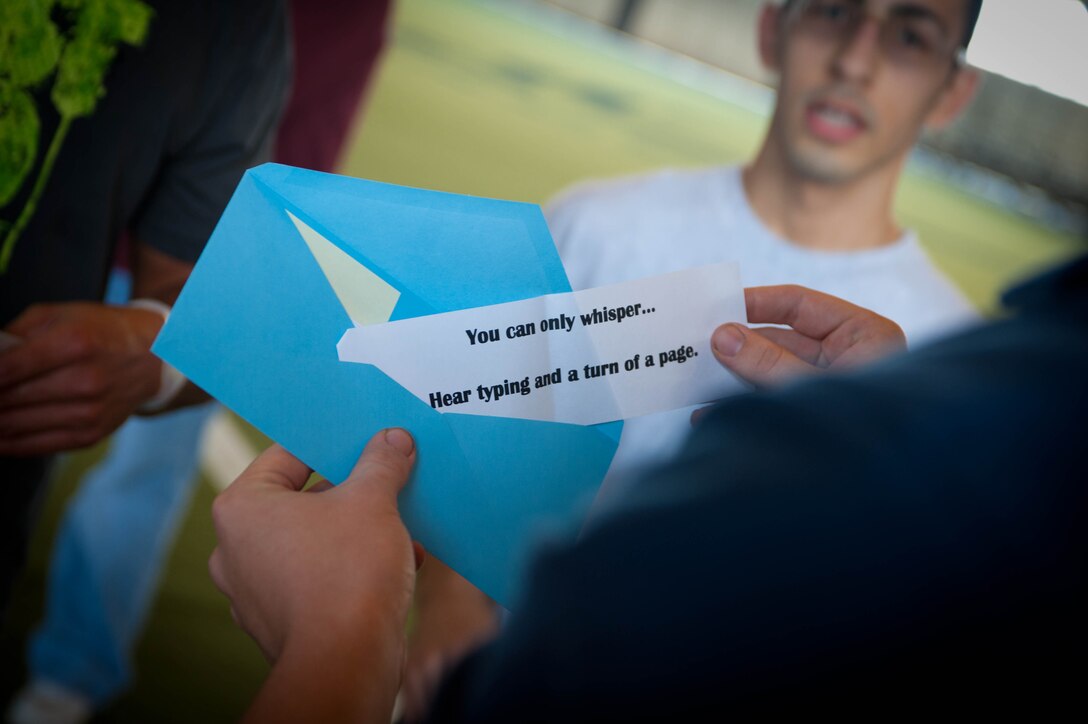 Airman 1st Class Luke Russel, 28th Force Support Squadron fitness specialist, gives a clue to participants of the base’s Amazing Race event to determine the location of the next challenge at Ellsworth Air Force Base, S.D., April 13, 2012. The 28th FSS plans to make the challenge, an enjoyable activity that promotes fitness, an annual event. (U.S. Air Force photo by Airman 1st Class Zachary Hada/Released)