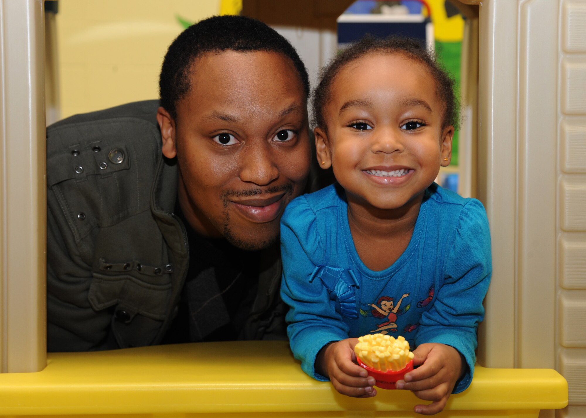 Andre Phillip,  spouse of 2nd Lt. Josline Phillip of the 319th Medical Support Squadron, poses with his daughter, Jaylene, on April 18, 2012, on Grand Forks Air Force Base, N.D.  The Phillips attended the bicycle helmet fitting held by Patty Olsen, sports coordinator of Safe Kids Grand Forks.  Safe Kids is a nationwide network of organizations working to prevent unintentional childhood injury, the leading cause of death and disability for children ages 1 to 14. (U.S. Air Force photo by Senior Airman Amber Bennett)