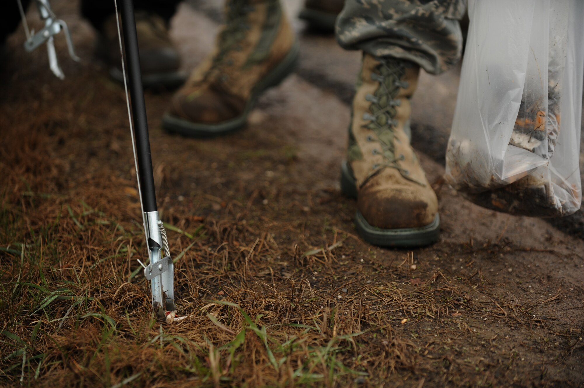 SPANGDAHLEM AIR BASE, Germany – A 52nd Fighter Wing volunteer picks up trash along the L-46 outside Spangdahlem AB April 20. Base members cleaned up roads surrounding the base, mainly along the L-46 and B-50, as part of an Earth Day initiative. The 52nd Civil Engineer Squadron is partnering with other base organizations and the local community to conserve natural resources, minimize waste and prevent pollution by hosting several Earth Day events on and off base. (U.S. Air Force photo by Airman 1st Class Matthew B. Fredericks/Released)