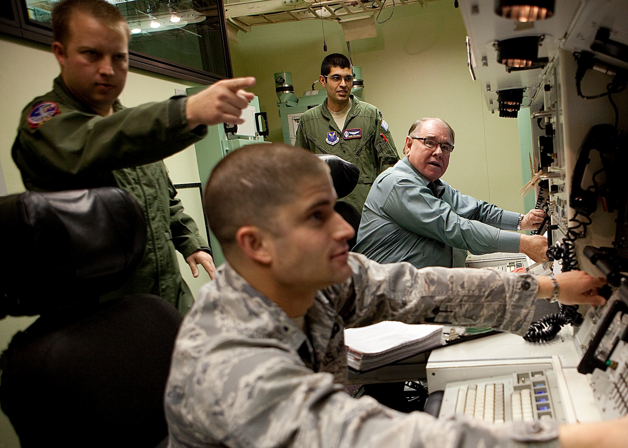 Michael Gaughan, an Air Force Chief of Staff civic leader, and 1st Lt. Thomas Cousino, 790th Missile Security Forces Squadron, take direction from Capt. James Henline, 90th Operations Support Squadron, during a stop at the Missile Procedure Trainer as part of Gaughan’s visit to the base April 12. (U.S. Air Force photo by Matt Bilden)