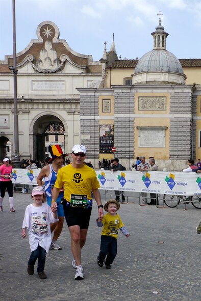 Lt. Col. Bryan Patchen, 603rd Air and Space Operations Center mission integration deputy commander runs with his children during a marathon in Rome on March 18, 2012. The marathon is one of four events in four different countries meant to commemorate four years since being diagnosed with cancer. (Courtesy Photo)