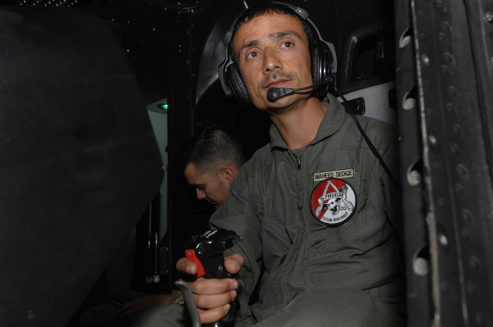 Afghan air force 1st Lt.Waheed Sediqe pilots a new MI-17 simulator at Kabul International Airport, April 18. The state-of-the-art simulator is able to recreate numerous different challenging scenarios to test and enhance the pilot's aviation abilities.  (U.S. Air Force photo by Tech. Sgt. Jeremy Larlee)
