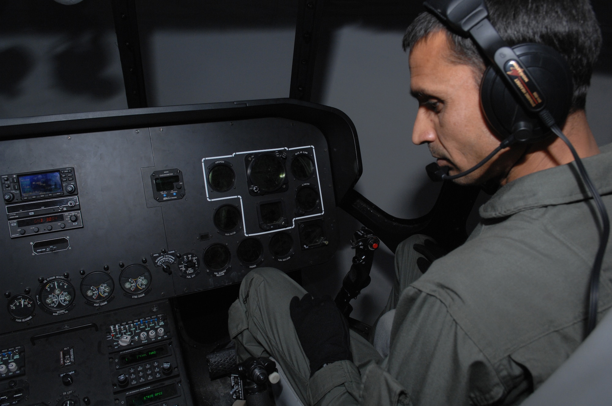 Afghan air force pilot 1st Lt. Nasrullah Khosti looks at the flight deck control panel in a new MI-17 simulator at Kabul International Airport, April 18. The state-of-the-art simulator is able to recreate numerous different challenging scenarios to test and enhance the pilot?s aviation abilities.  (U.S. Air Force photo by Tech. Sgt. Jeremy Larlee)
