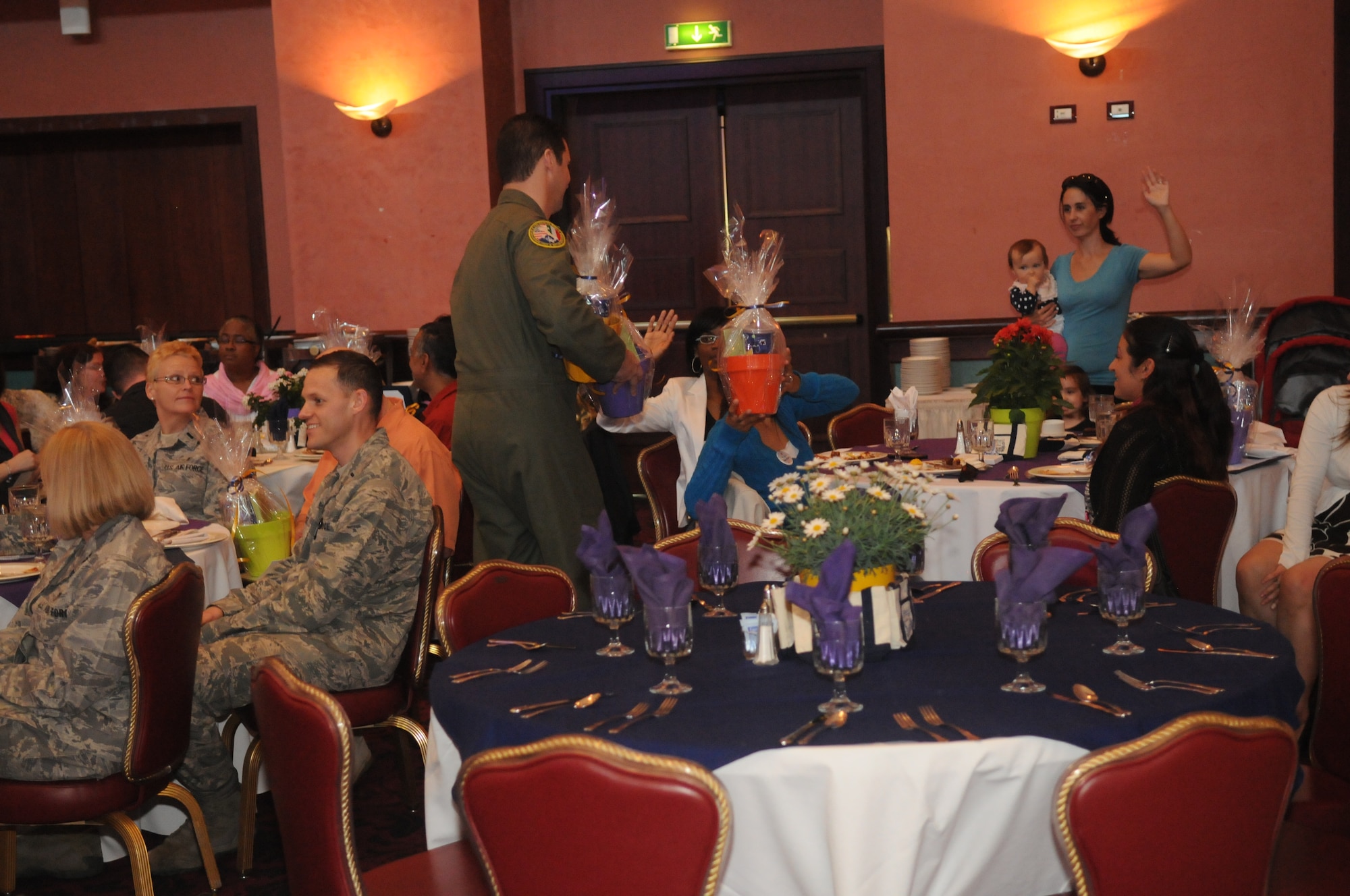 Col. Dean Ostovich, 31st Fighter Wing vice commander, hands out gift baskets during the annual Volunteer Appreciation Ceremony April 17 at Aviano Air Base, Italy. More than 70 volunteers attended the ceremony, representing just a portion of base’s volunteer community which donated 124,873 hours of their time in 2011. (U.S. Air Force photo/Airman 1st Class Jenay Randolph)