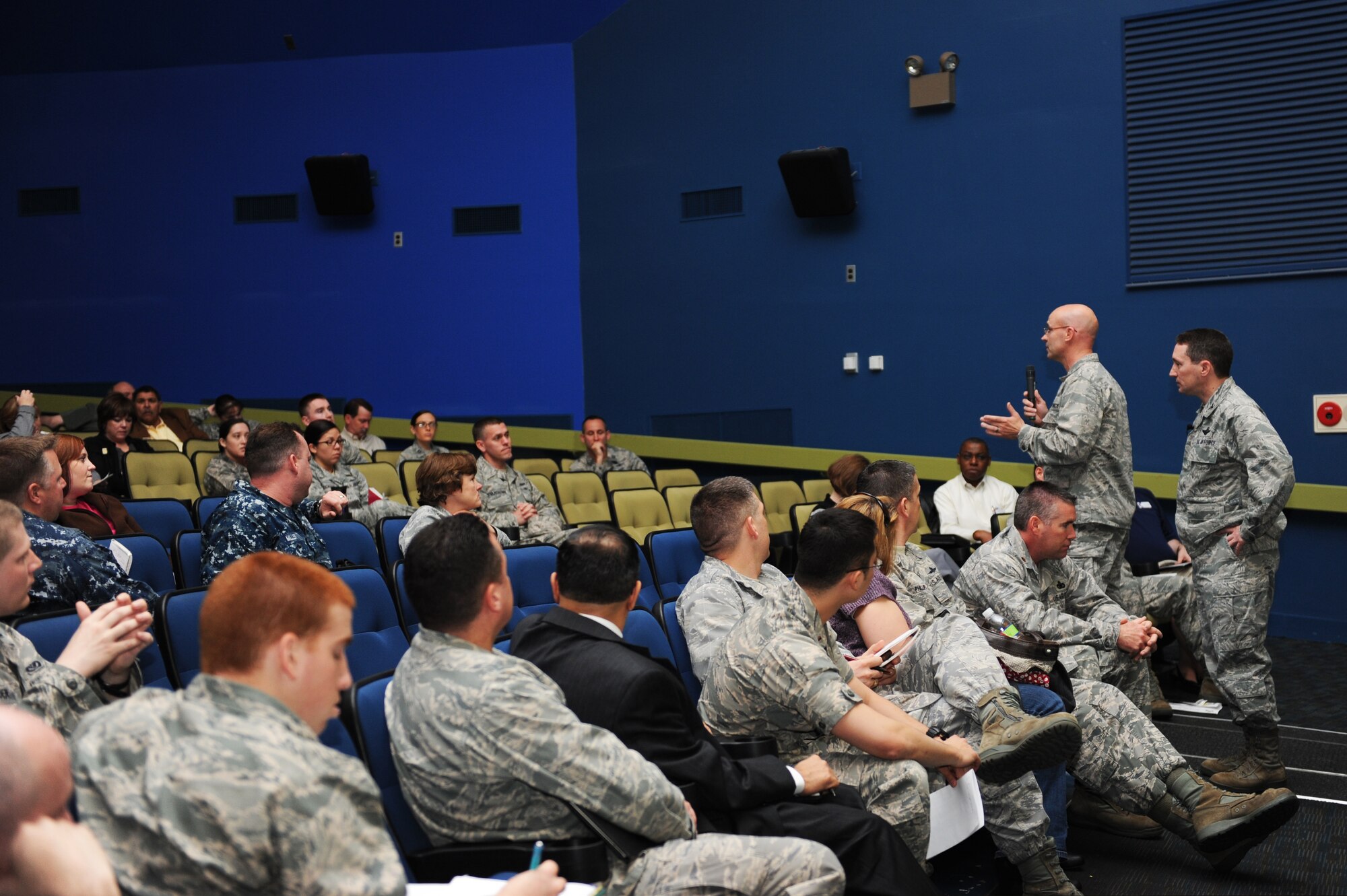 From right standing, Col. Michael Rothstein, 35th Fighter Wing commander, and Lt. Col. Dwayne Robison, 35th Civil Engineer Squadron commander, answer questions during a town hall meeting at Misawa Air Base, Japan, April 20, 2012. Some of the topics that discussed were the operations tempo, Misawa family housing and changes at the base clinic. The purpose of town hall meetings are to give families in the Misawa Air Base community direct access to wing leadership and answer any questions they may have. (U.S. Air Force photo by Airman 1st Class Kia Atkins/Released)