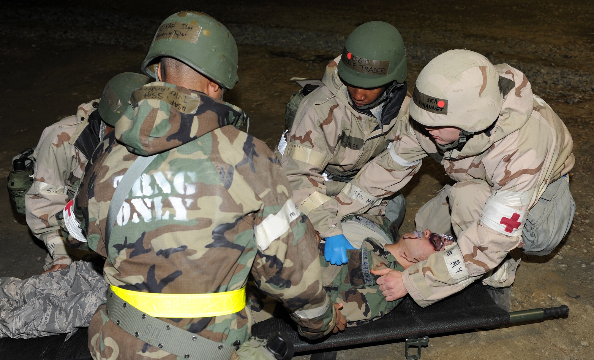 Airmen from the 633rd Medical Group lift a simulated victim onto a litter during the phase II operational readiness exercise at Langley Air Force Base, Va., April 19, 2012. The phase II ORE is designed to simulate a deployed environment and test the combat abilities of Airmen, such as self-aid and buddy care, and post-attack reconnaissance. (U.S. Air Force photo by Airman 1st Class Teresa Cleveland/Released)