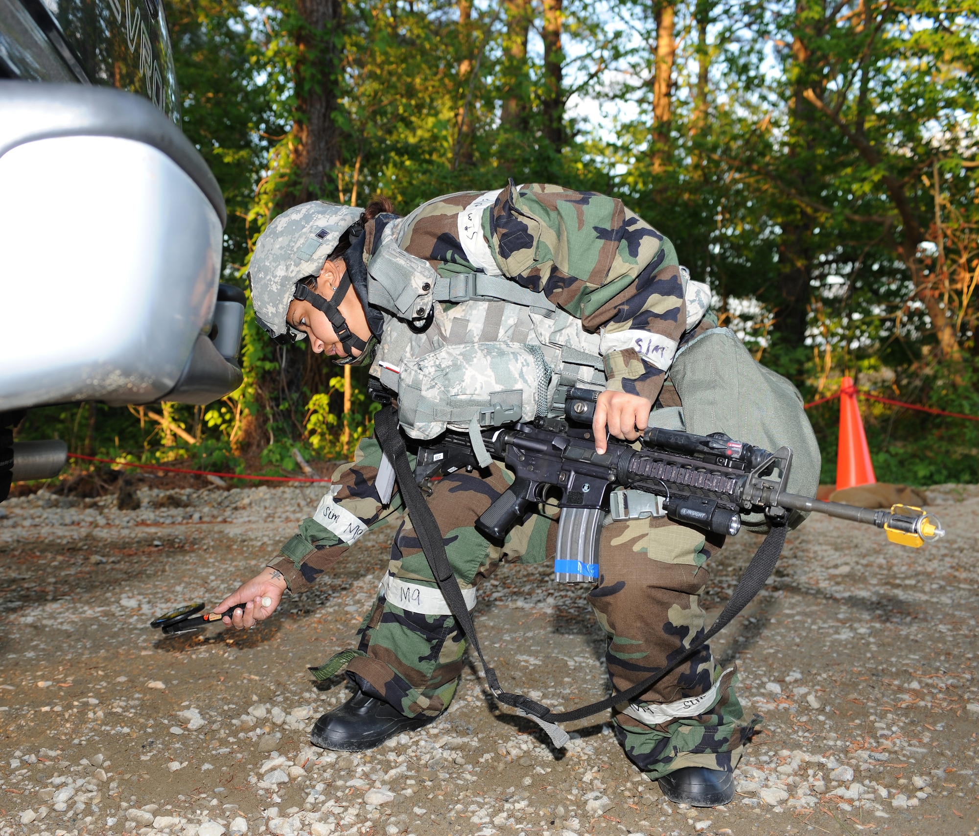 U.S. Air Force Senior Airman Gisselle Tucker, 633rd Security Forces Squadron response force leader, inspects a vehicle during a phase II operational readiness exercise at Langley Air Force Base, Va., April 19, 2012. Airmen participated in the phase II ORE to practice for upcoming exercises and inspections. (U.S. Air Force photo by Airman 1st Class Teresa Cleveland/Released)