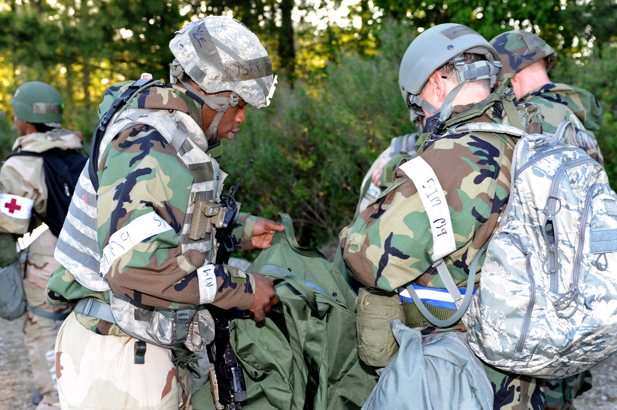 U.S. Air Force Senior Airman Rashad Boyce, 633rd Security Forces Squadron response force leader, verifies identification and inspects gear during a phase II operational readiness exercise at Langley Air Force Base, Va., April 19, 2012. The exercise provided training, and prepared Airmen for worldwide deployments. (U.S. Air Force photo by Airman 1st Class Teresa Cleveland/Released)