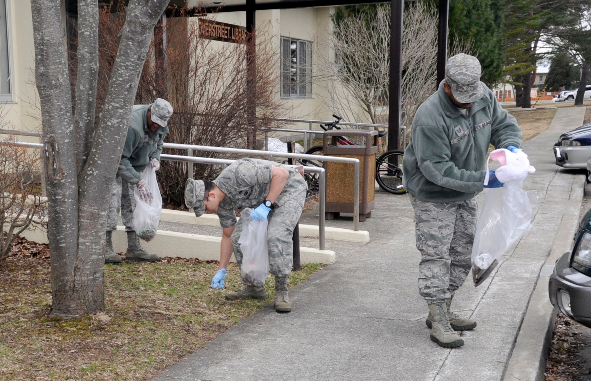 Left to right; U.S. Air Force Staff Sgt. Kevin Dotson, 35th Fighter Wing Ground Safety craftsman, 2nd Lt. Steven Harvey, 35 FW Financial Management flight commander and Tech. Sgt. Arzie Gordon, 35 FW Equal Opportunity director, pick up trash on base as part of the Misawa Air Base Spring Clean-up at Misawa Air Base, Japan, April 20, 2012. Servicemembers throughout the base spent the morning picking up litter to improve appearances. (U.S. Air Force photo by Airman 1st Class Kaleb Snay/Released)