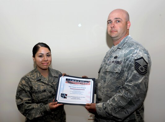 Staff Sgt. Christy Garcia-Holguin, 39th Force Support Squadron readiness and plans technician, receives the Unsung Hero Award from Master Sgt. Bryan Tuika-Soske, Incirlik Top 3, April 19, 2012, at Incirlik Air Base, Turkey. The Top 3 presents this award monthly to Airmen who demonstrate superior job performance and exceptional leadership. (U.S. Air Force photo by Senior Airman Jarvie Z. Wallace)
