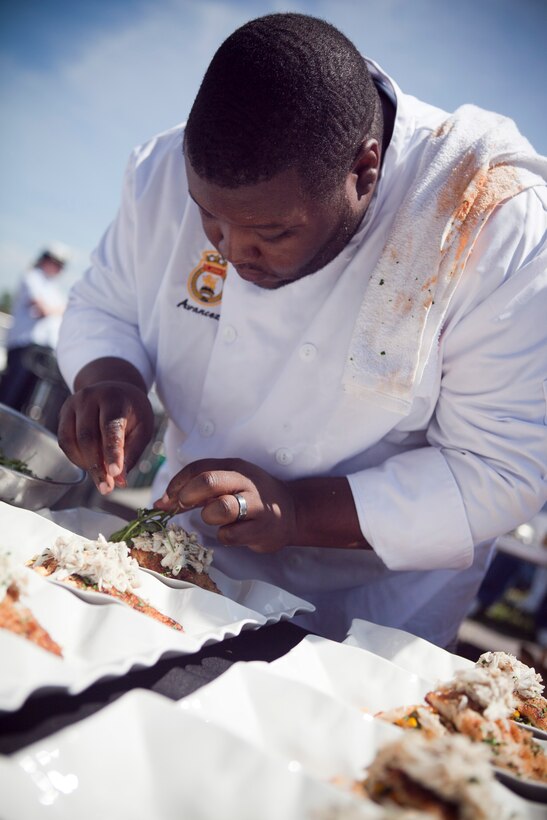 Alfred Singleton, the executive chef at Dickie Brennan’s Steakhouse, prepares a dish during the Louisiana Seafood Cook-Off, April 20, 2012. The cook-off was held as part of the War of 1812 Commemoration. New Orleans will serve as the inaugural city in a three-year national celebration commemorating the War of 1812 and the Star-Spangled Banner. The Marine Corps’ role in this event reinforces its naval character, showcases the Navy-Marine Corps team and highlights the military’s enduring relationship with the city of New Orleans. (U.S. Marine Corps photo by Lance Cpl. Marcin Platek/Released)