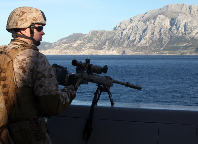 USS NEW YORK - Cpl. Sean S. Jeffries, a scout sniper with Battalion Landing Team 1st Battalion, 2nd Marine Regiment, 24th Marine Expeditionary Unit, stands ready behind an M40A5 sniper rifle to provide security for the ship as she passes through the Straits of Gibraltar, April 20, 2012. The 24th MEU is currently deployed with the Navy's Iwo Jima Amphibious Ready Group as a theater reserve and crisis response force capable of a variety of missions from full-scale combat operations to humanitarian assistance and disaster relief. (Official Marine Corps Photo by Staff Sgt. Robert L. Fisher III)