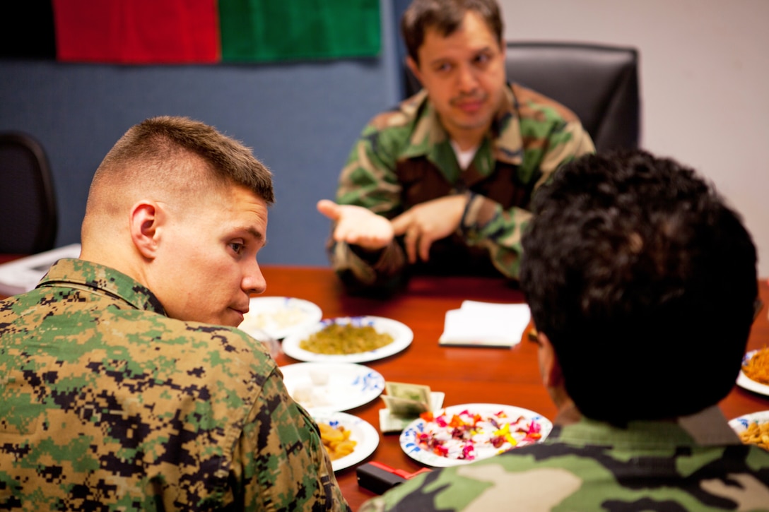 1st Lt. David Pursel, the logistics officer with a police advisory team preparing to deploy to Afghanistan, talks to Afghan role-players at the Advisory Training Cell, II Marine Expeditionary Force Headquarters Group, aboard Marine Corps Base Camp Lejeune, N.C., Feb. 28. Talking with the role-players helped Pursel, a native of Jacksonville, N.C., and the rest of his team prepare for the cultural differences between themselves and the Afghans they will be working hand-in-hand with during their upcoming seven-month deployment to Washir district, Helmand province.
