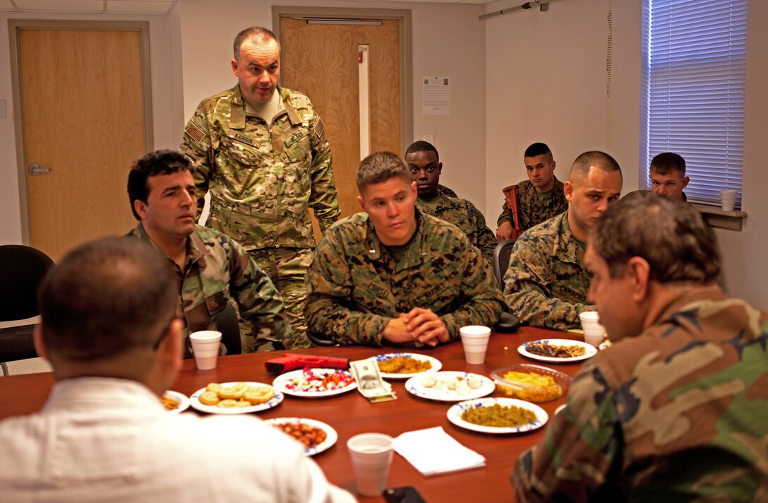 1st Lt. David Pursel (center), the logistics officer with a police advisory team preparing to deploy to Afghanistan, talks to Afghan role-players at the Advisory Training Cell, II Marine Expeditionary Force Headquarters Group, aboard Marine Corps Base Camp Lejeune, N.C., Feb. 28, alongside the rest of the Marines and sailors on his team. Talking with the role-players helped Pursel, a native of Jacksonville, N.C., and the rest of his team prepare for the cultural differences between themselves and the Afghans they will be working hand-in-hand with during their upcoming seven-month deployment to Washir district, Helmand province.