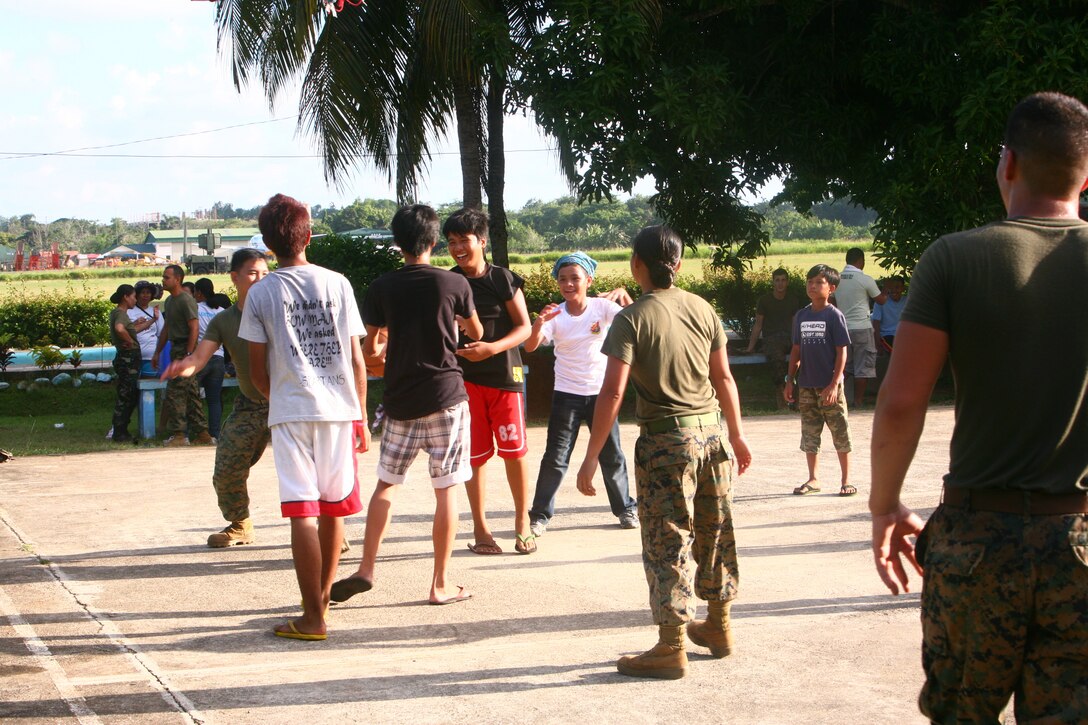 Filipino children from the Bahay Ni Nanay Orphanage joke with one another during basketball game with U.S. Marines and sailors at Antonio Bautista Air Base in Puerto Princesa, Palawan, Republic of the Philippines, April 21, 2012. The children and service members spent several hours together getting to know one another. The service members are currently here for the duration of Balikatan 2012 and are a part of Task Force Palawan. BK12 is a bilateral, joint exercise conducted annually between the U.S. and the Republic of the Philippines. This year marks the 28th iteration of the nations' exercise.