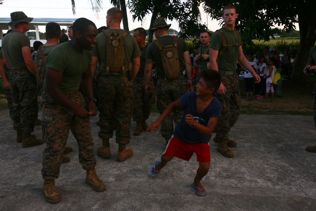 A Filipino child from the Bahay Ni Nanay Orphanage jokes with a U.S. Marine at Antonio Bautista Air Base in Puerto Princesa, Palawan, Republic of the Philippines, April 21, 2012. The children of the orphanage, Marines and sailors spent several hours together getting to know one another. The service members are currently here for the duration of Balikatan 2012 and are a part of Task Force Palawan. BK12 is a bilateral, joint exercise conducted annually between the U.S. and the Republic of the Philippines. This year marks the 28th iteration of the nations' exercise.